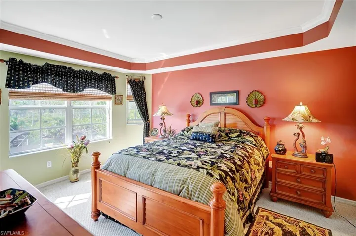 Bedroom featuring crown molding, carpet floors, and baseboards