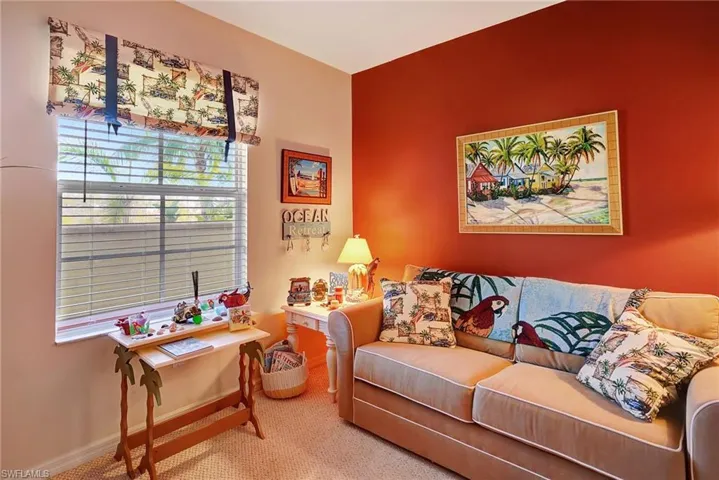 Carpeted living area featuring baseboards