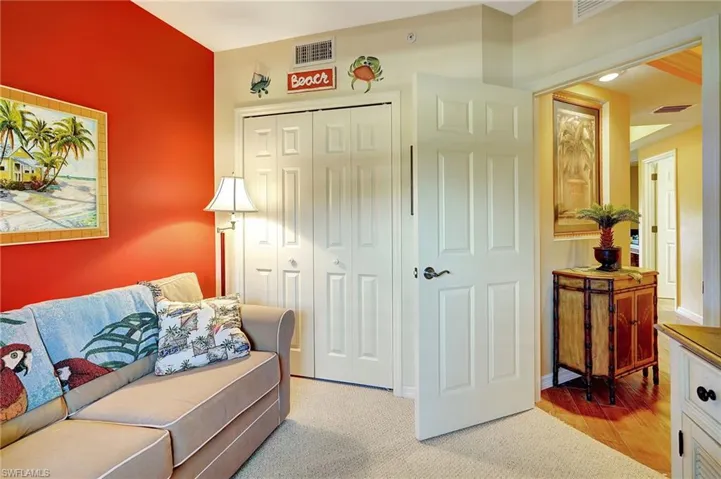 Living room featuring visible vents, light carpet, and baseboards