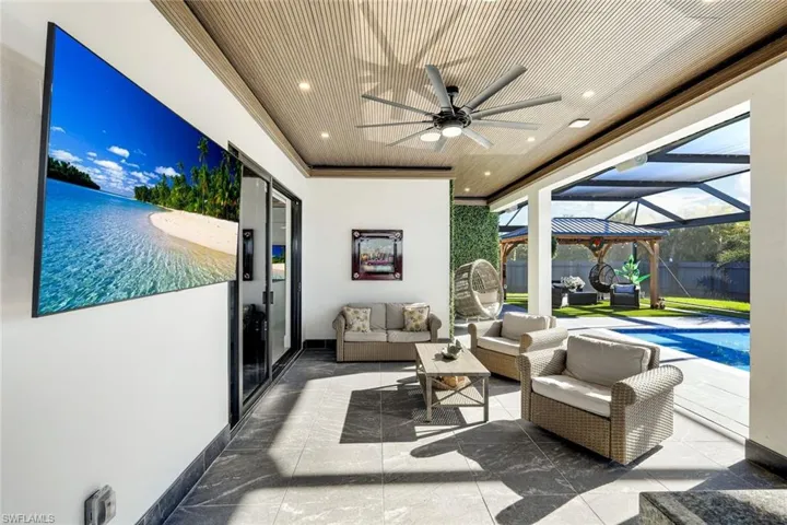 View of patio with a fenced in pool, an outdoor living space, fence, a lanai, and a ceiling fan