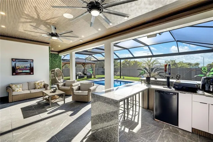View of patio featuring fence, a fenced in pool, area for grilling, outdoor lounge area, and a lanai