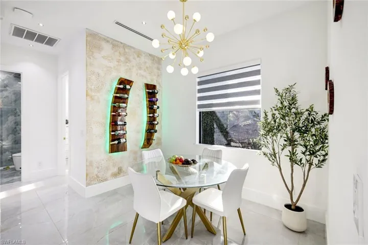 Dining area with baseboards, visible vents, and a chandelier