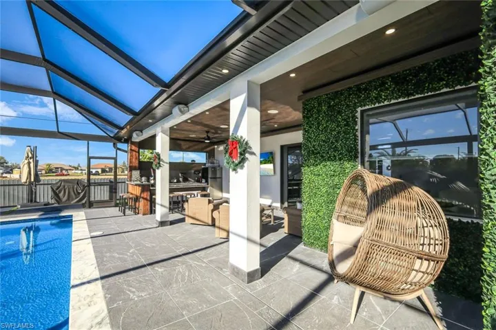 View of swimming pool with a ceiling fan, an outdoor living space, a fenced in pool, a lanai, and a patio area