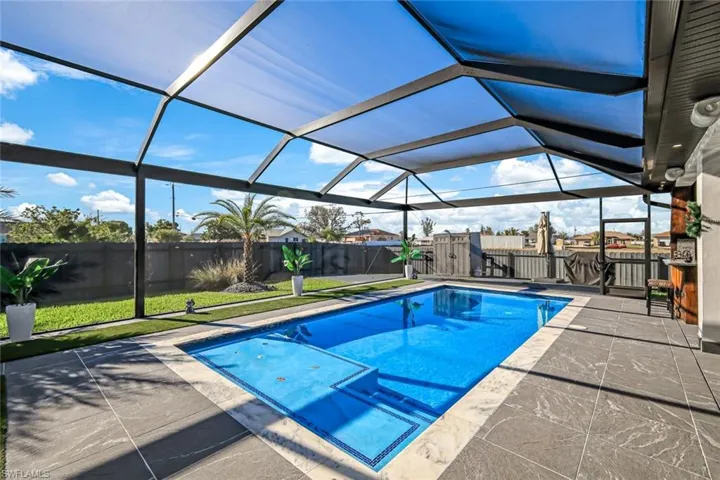 View of swimming pool featuring a patio area, a fenced in pool, a lanai, and a fenced backyard