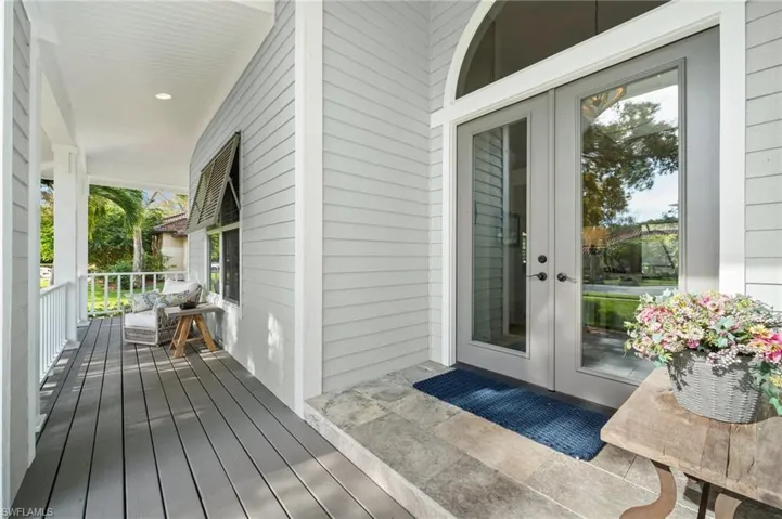 Entrance to property with covered porch and french doors