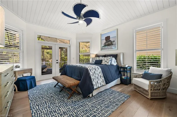 Bedroom featuring ceiling fan, french doors, light hardwood / wood-style floors, access to outside, and wood ceiling