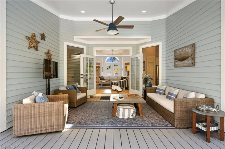 Living room with french doors, light hardwood / wood-style floors, ceiling fan, and ornamental molding