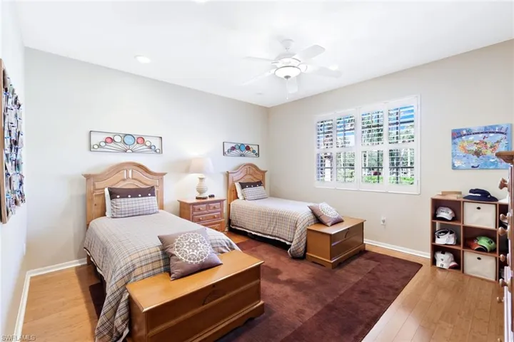 Bedroom with wood-type flooring and a ceiling fan
