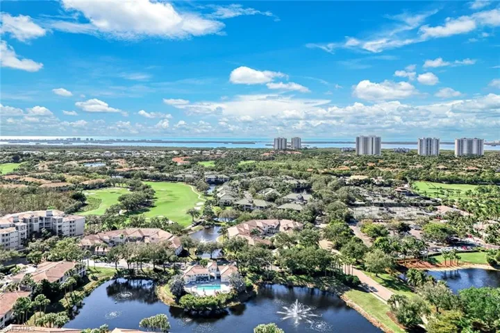 Drone / aerial view of a large body of water and a golf course