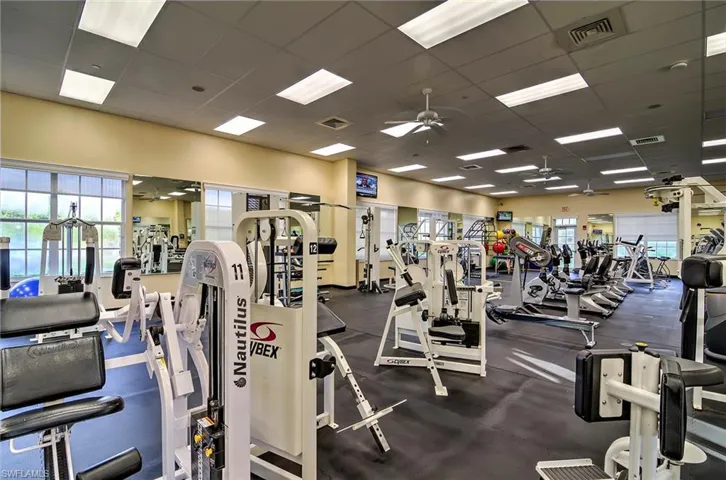 Workout area featuring a drop ceiling and ceiling fan