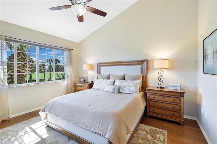 Bedroom featuring vaulted ceiling, wood finished floors, and ceiling fan