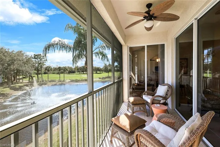 Balcony featuring ceiling fan and a water view