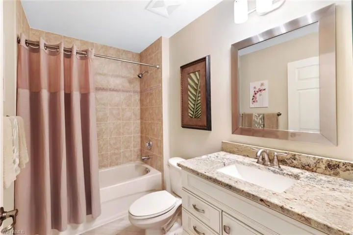 Bathroom with shower / tub combo and vanity