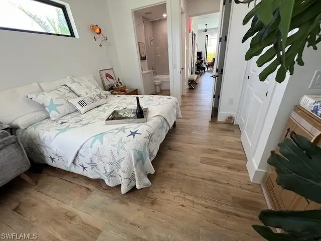 Bedroom featuring light wood-style flooring and connected bathroom