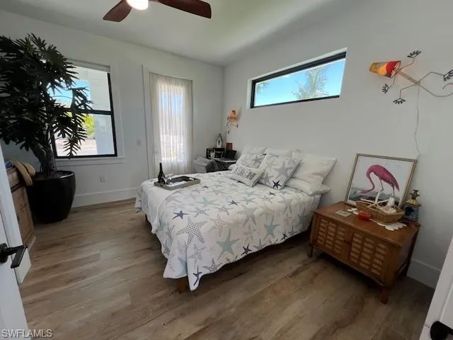Bedroom with wood finished floors and ceiling fan