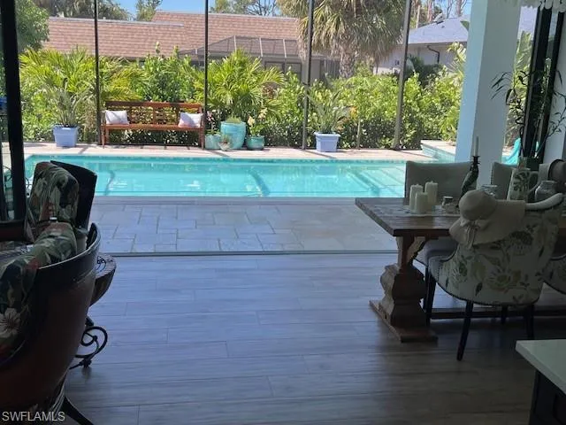 Outdoor pool with a patio area and a lanai