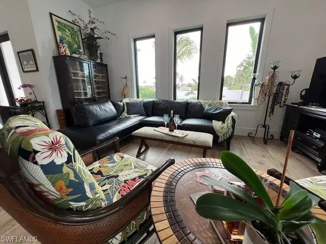 Living area with plenty of natural light and wood finished floors