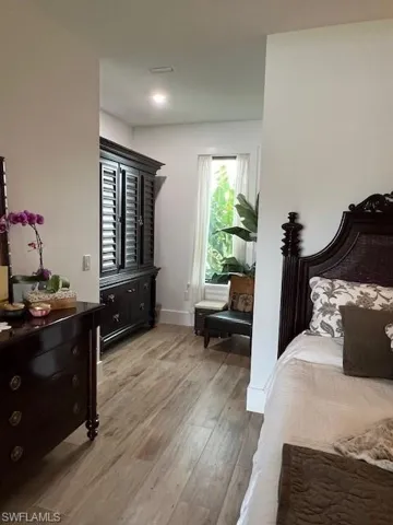 Bedroom with light wood-style flooring and baseboards