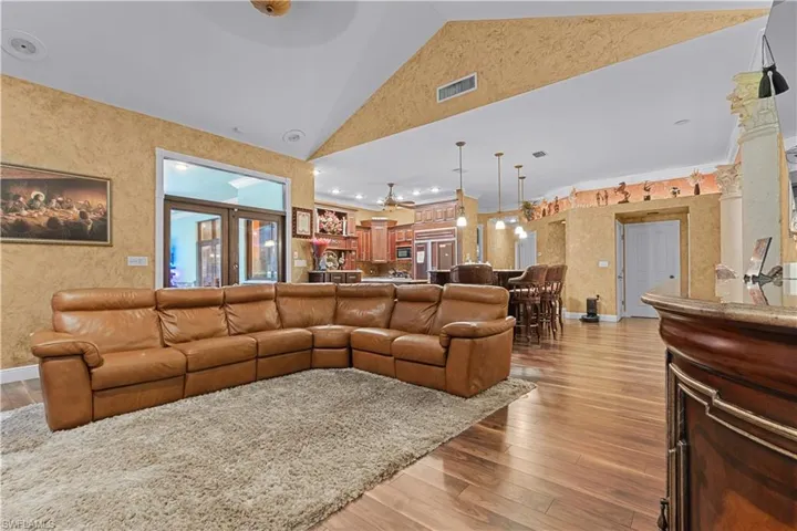 Spacious living area featuring wood-finish flooring and a textured wall finish