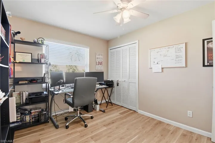 Office area featuring light wood finished floors and ceiling fan