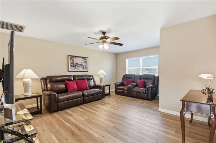 Living area featuring light wood-style flooring and ceiling fan