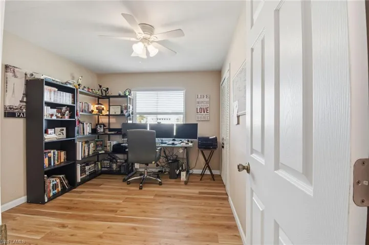 Office area featuring light wood-type flooring and ceiling fan