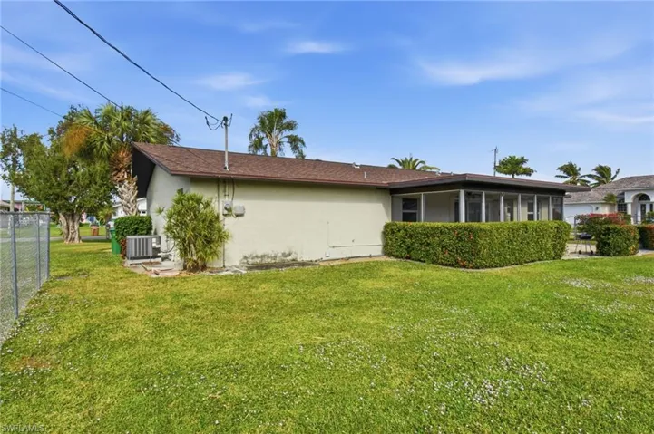 View of property exterior with stucco siding and a sunroom