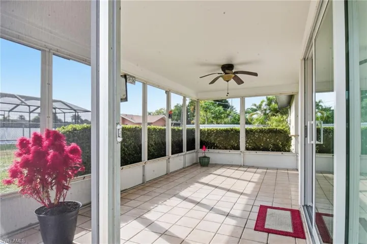 Unfurnished sunroom featuring ceiling fan and healthy amount of natural light