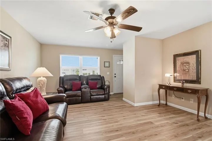 Living room featuring light wood-style floors and a ceiling fan