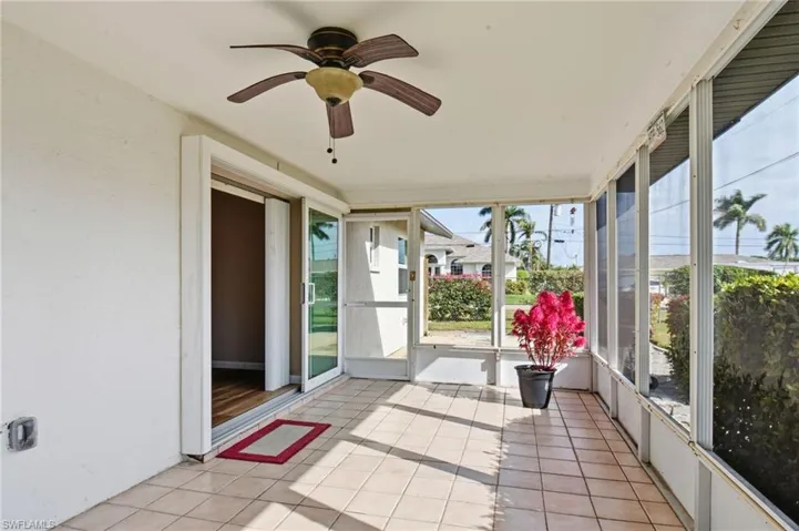 Unfurnished sunroom with ceiling fan and healthy amount of natural light