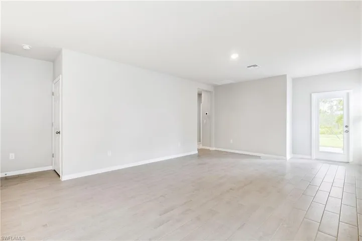 Spare room with light wood-style floors and a smoke detector