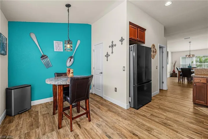 Dining room featuring light wood finished floors and baseboards