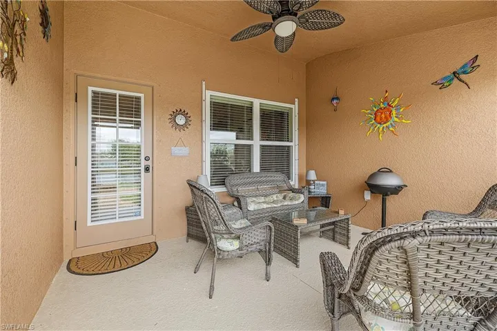 View of patio with an outdoor living space and a ceiling fan