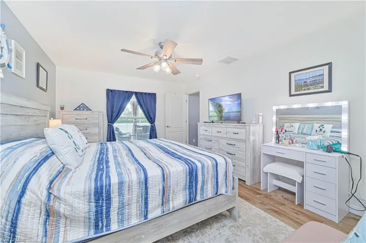 Bedroom with a ceiling fan and light wood-style floors
