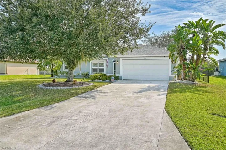 View of front of house with driveway, an attached garage, stucco siding, and a shingled roof