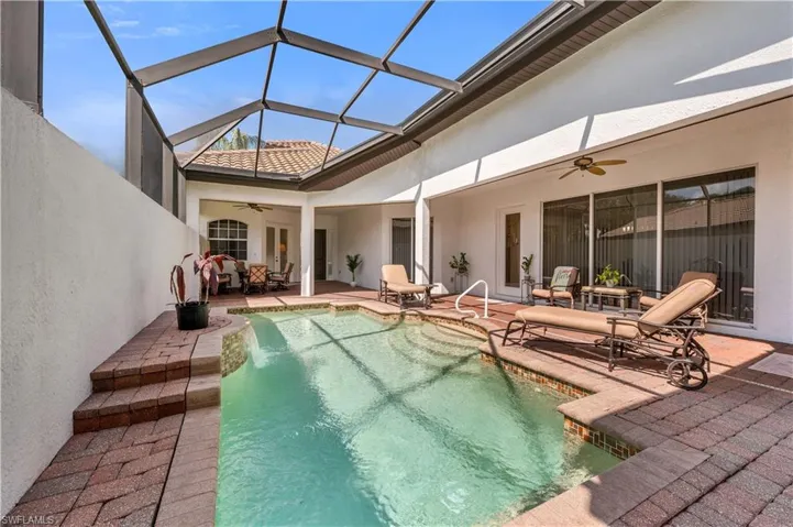 Pool with a lanai, a ceiling fan, and a patio