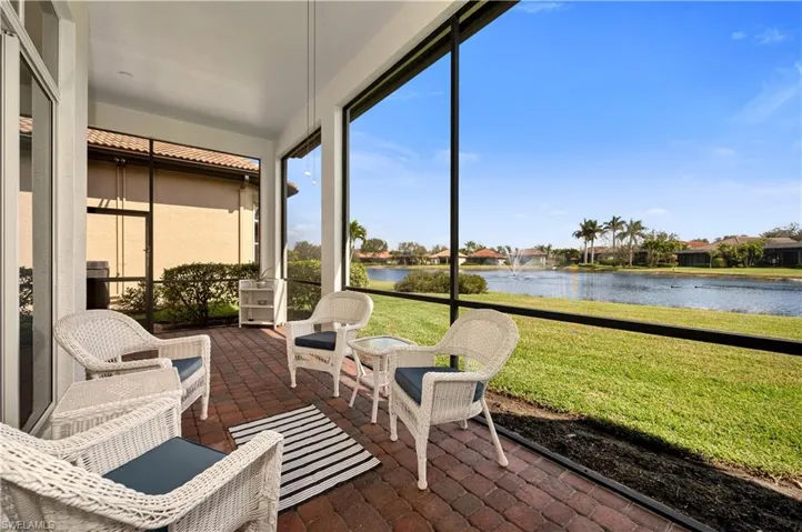 Sunroom / solarium featuring a water view