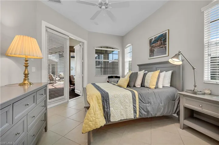 Bedroom with access to outside, multiple windows, visible vents, and light tile patterned flooring