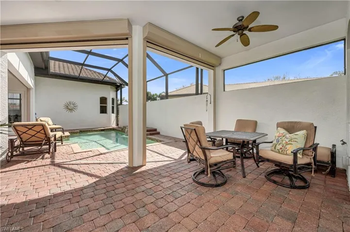 View of patio / terrace featuring a lanai and a ceiling fan