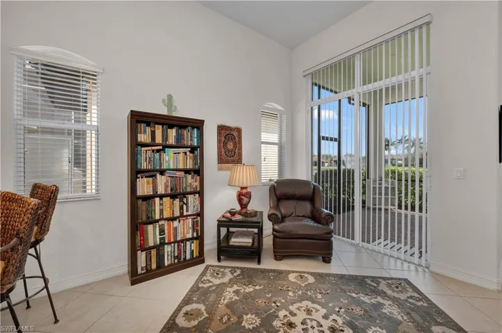 Living area with baseboards and tile patterned floors
