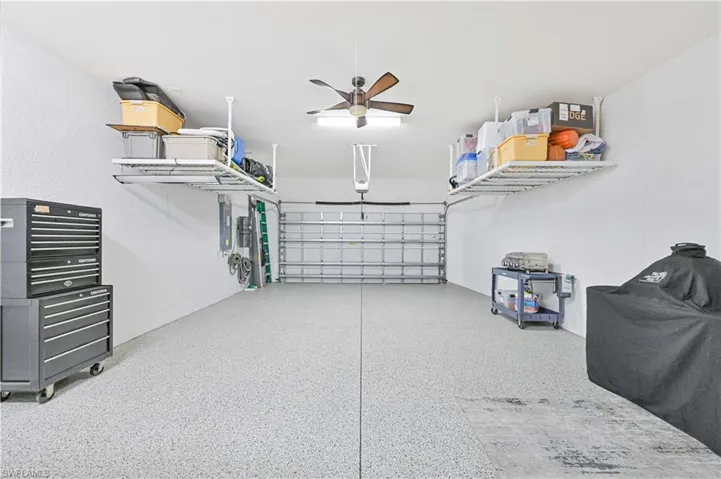 Garage featuring a ceiling fan and electric panel
