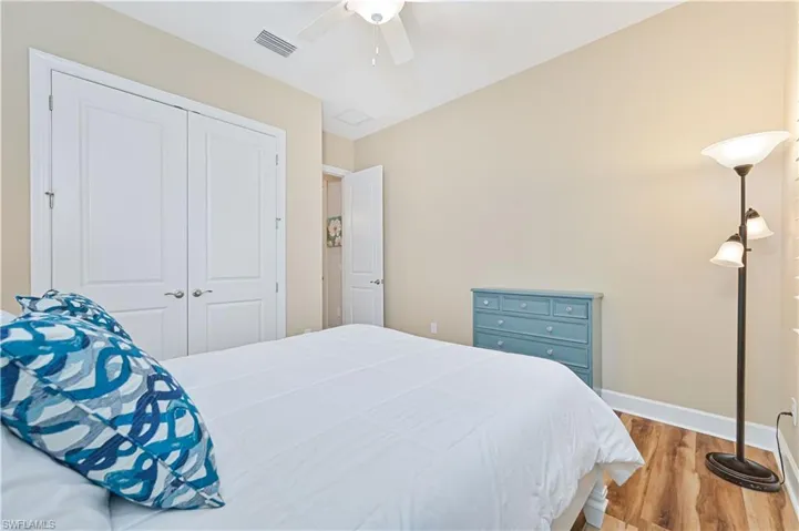 Bedroom featuring wood finished floors, a ceiling fan, and a closet