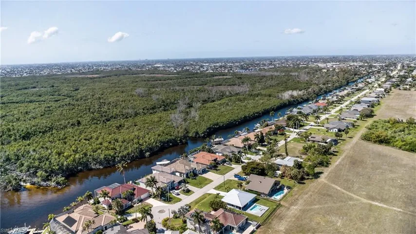 Aerial view of residential area featuring a large body of water