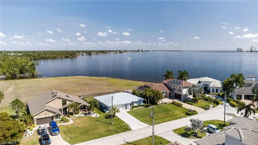 Aerial view of residential area featuring a large body of water
