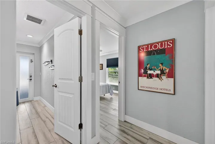 Hall featuring ornamental molding and light wood-style floors