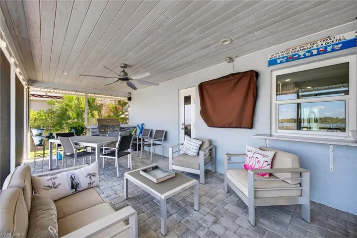 View of patio with a ceiling fan and an outdoor living / dining area