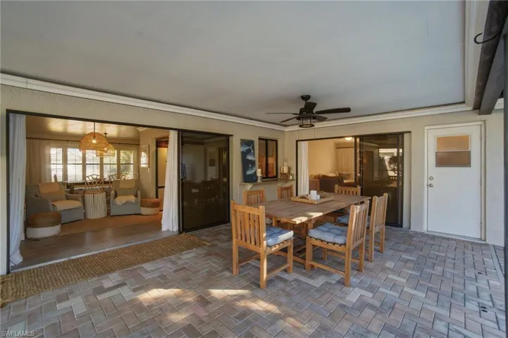 Dining space featuring brick patterned floors, ceiling fan, and crown molding