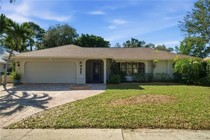Single story home featuring stucco siding, decorative driveway, a front yard, a shingled roof, and an attached garage