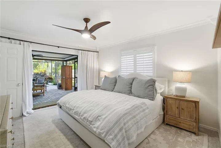 Bedroom featuring ornamental molding, access to outside, a ceiling fan, and carpet flooring