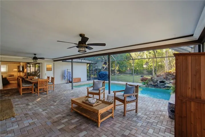 View of patio featuring an outdoor pool, a lanai, an outdoor hangout area, and a sunroom